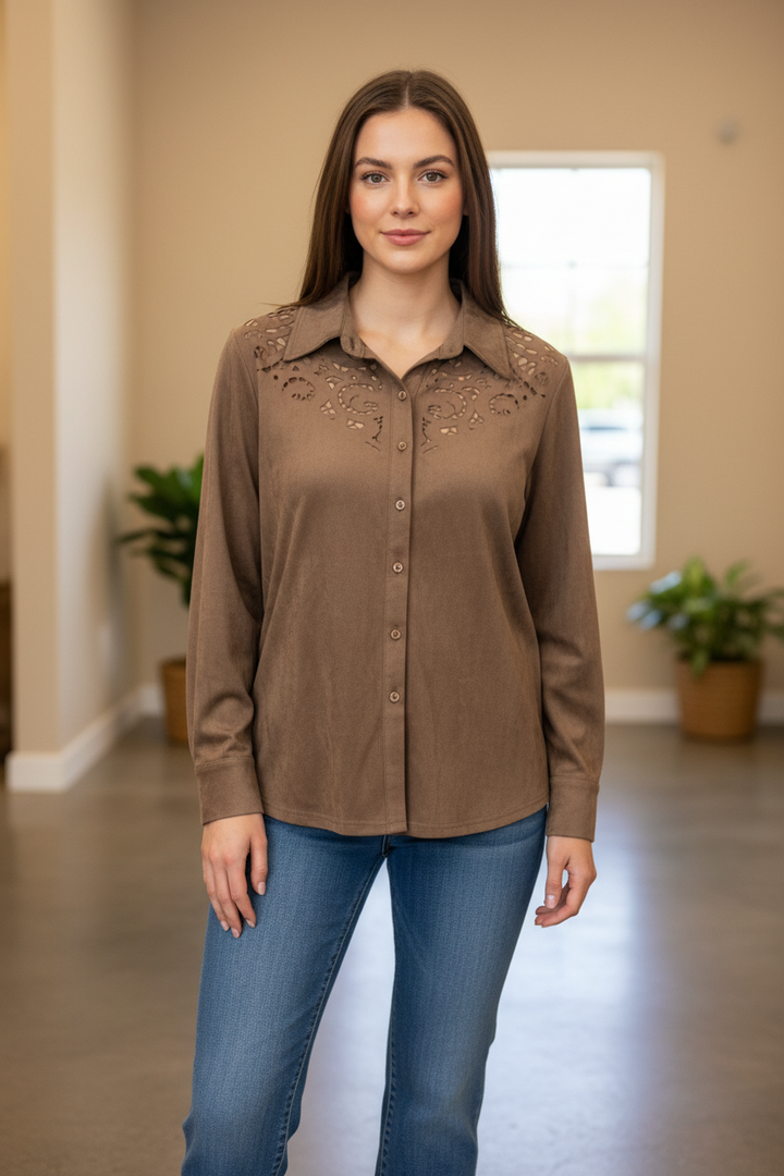 Model wearing a warm taupe button-front top with decorative cutout yoke detailing in a front-facing pose.
