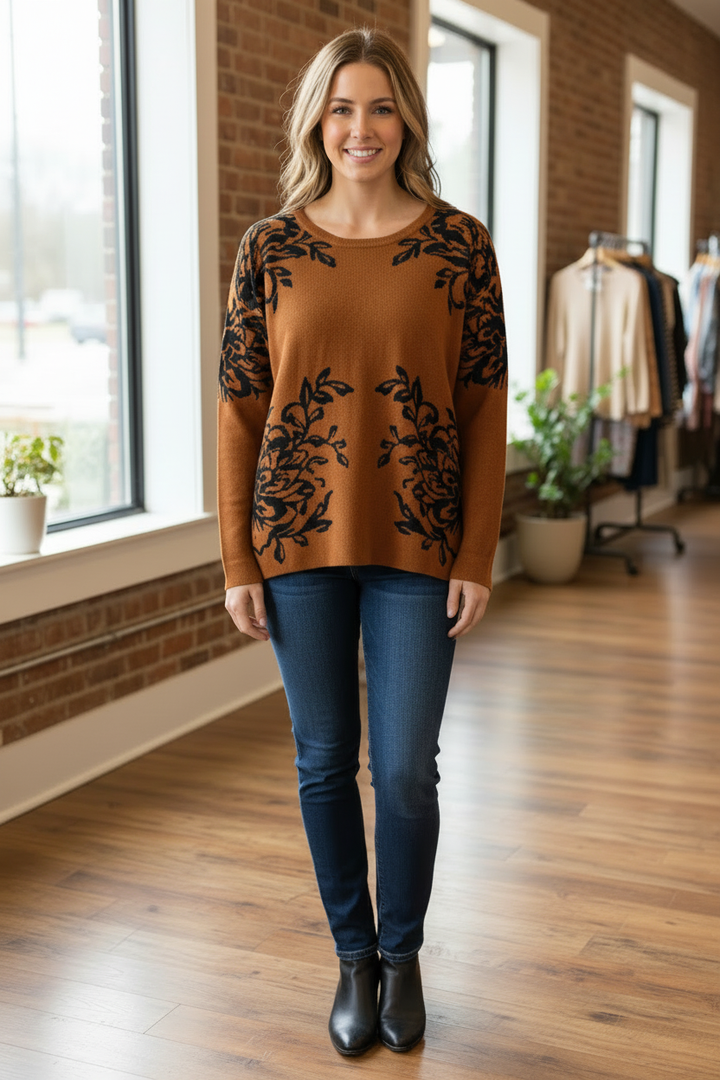 Model wearing a rust-colored Fransa top with black botanical print in a front-facing pose.